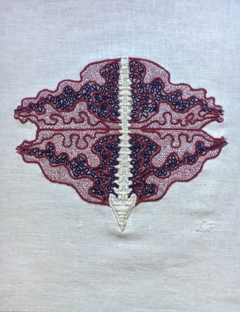 In the centre of some bone white linen, there is a spine embroidery in thick satin stitch. Emanating from the spine are thick burgundy lines in an undulant oval shape. This oval is bisected across the middle. In the top half, there is a section outlined in burgundy filled with coiling blue lines and a similar section in the bottom half. The rest of the undulant oval is filled with fine coiling burgundy lines. The spine is very straight, the rest of the embroidery is very coiled and busy. Lia’s initials are stitched in fine thread the same colour as the cloth at the bottom right.