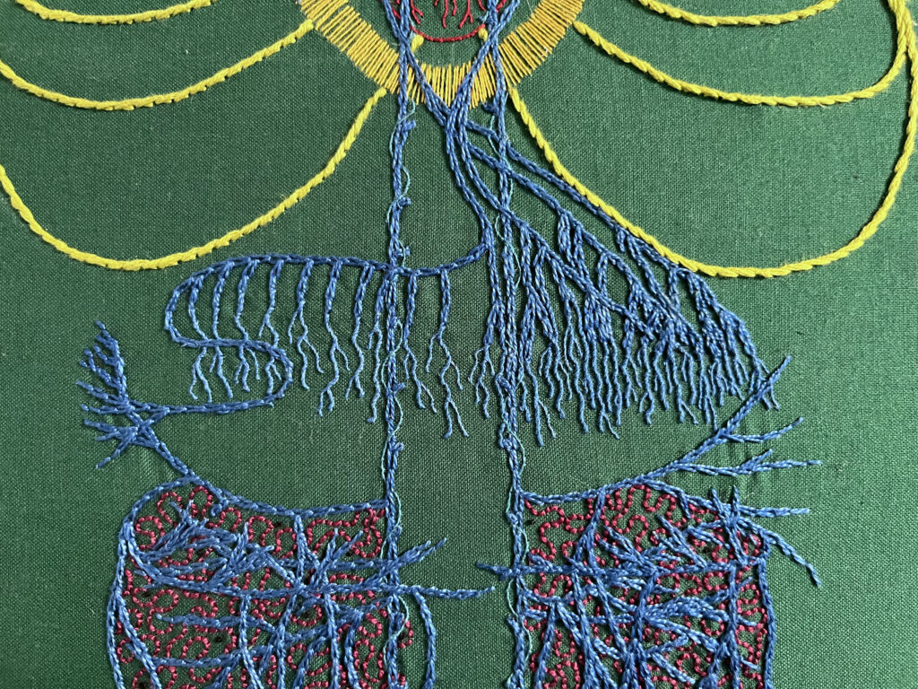 A close up of an embroidery focused on the diaphragm of the vagus nerve stitched in blue chain stitch in perlé thread on dark green cotton. Spiralling around the very straight main vagus is single strand whipped back stitch in electric blue. The bottom of a red heart with some yellow lines around it are above the diaphram. The nerve endings in the diaphragm area are lengthened with one and two strand whipped back stitch. The abdomen has many layers of crossing wavy lines. Some roiling burgundy back stitch in burgundy perlé thread is between the blue. Sparse tiny black French knots are stitched in the gut area. 