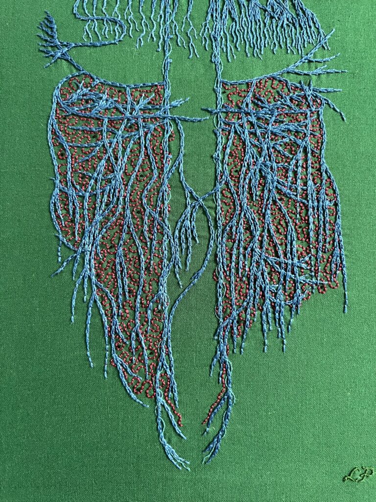 A close up of an embroidery focused on the abdominal vagus stitched in blue chain stitch in perlé thread on dark green cotton. There are many layers of crossing wavy lines. Spiralling around the very straight main vagus is single strand whipped back stitch in electric blue. Some roiling burgundy back stitch in burgundy perlé thread is between the blue. Sparse tiny black French knots are stitched in the gut area. The nerve endings in the diaphragm area are lengthened with one and two strand whipped back stitch.