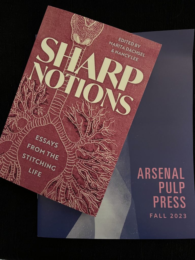 The book Sharp Notions: Essays from the Stitching Life featuring Lia’s lung embroidery on the pink cover. The book sits atop the Arsenal Pulp Press Fall 2023 catalog.
